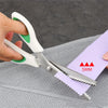 A hand is using professional pinking shears to cut a purple paper strip marked 5mm.