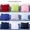 A grid display of colorful ruffled pillow covers in various shades including red, lime green, pink, blue, and white.