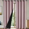A pair of modern pink blackout grommet curtains with a black accent panel hanging in a light-colored room.