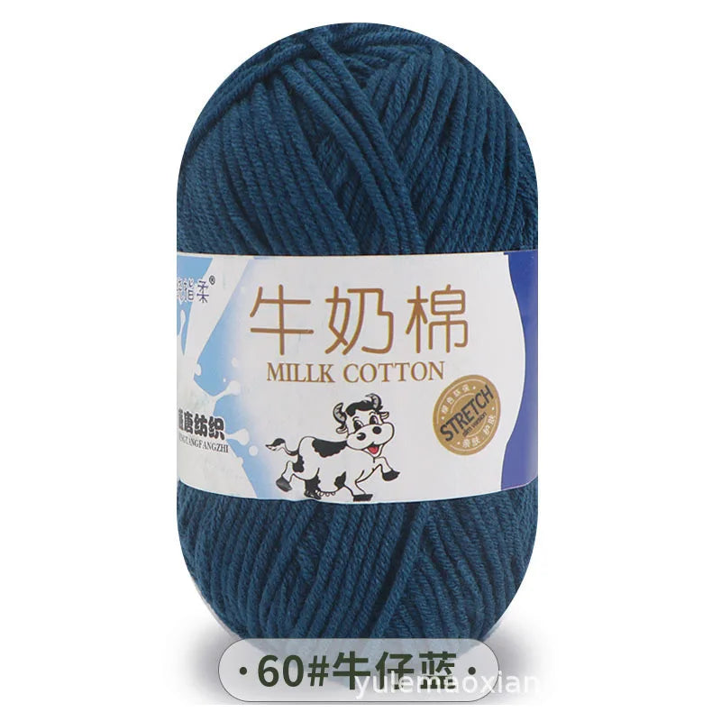 A skein of dark blue milk cotton yarn with a label featuring Chinese text and a stretch icon.
