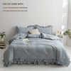 A gray plaid duvet cover set displayed on a bed with pillows and bedding.