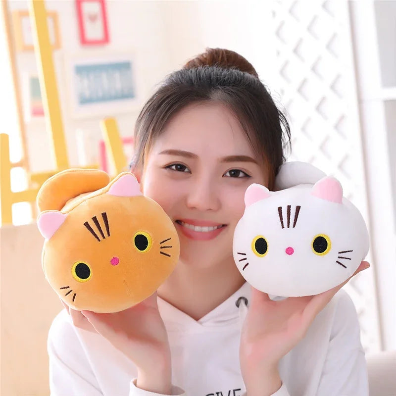 A woman is holding a soft orange cat plush pillow cushion in front of her.