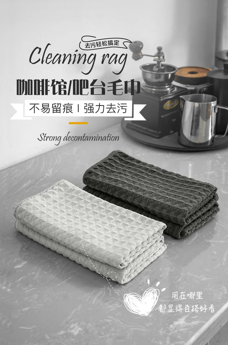 A stack of gray cleaning rags is shown next to a coffee machine, demonstrating strong decontamination.