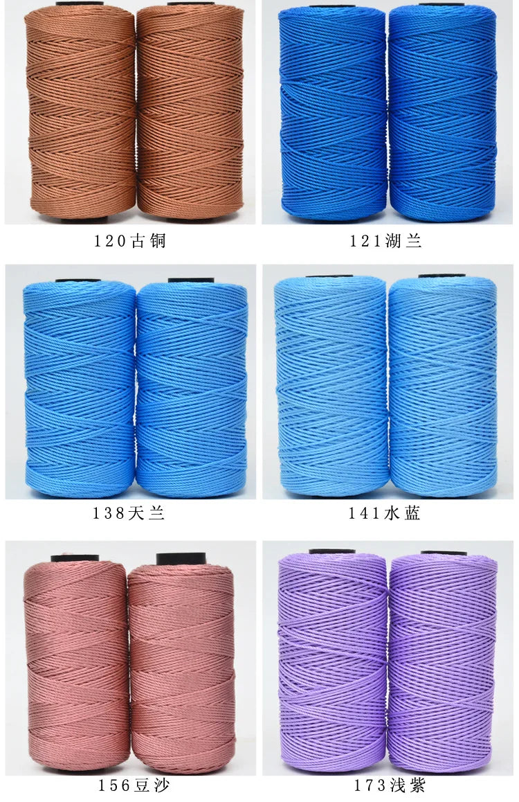 A collection of hand knitting and crochet cord spools in various shades of pink, blue, and purple.