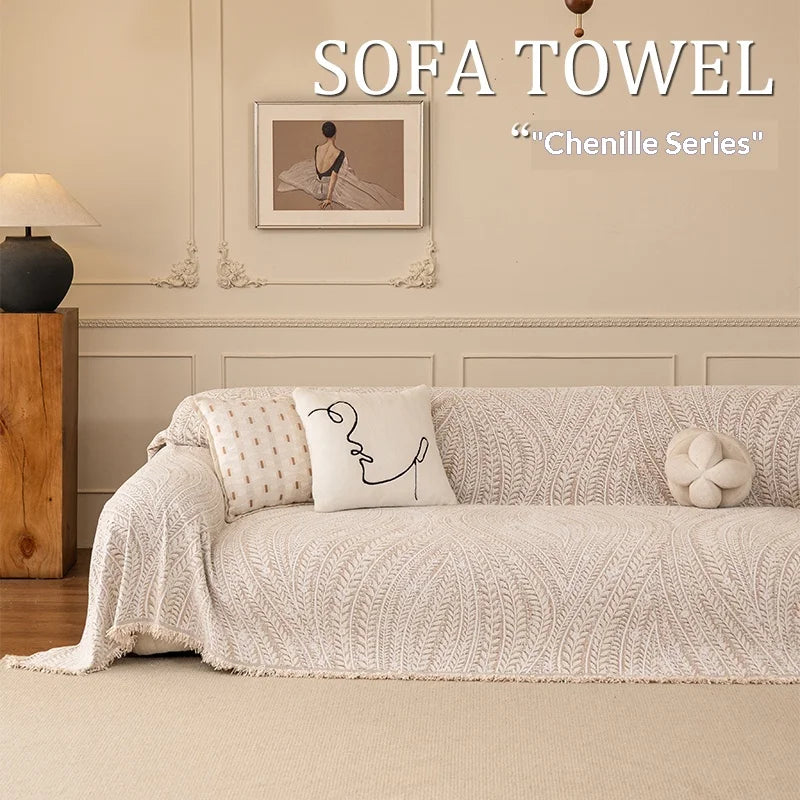 A cream colored sofa towel featuring an elegant herringbone texture and a minimalist line art design.