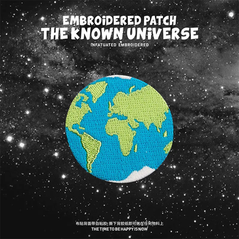 Embroidered patch featuring a globe of Earth against a starry space background.
