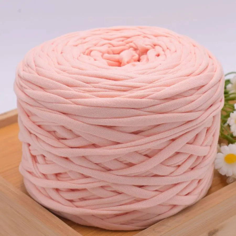 A ball of pink craft yarn made from 100% polyester for knitting and DIY projects.
