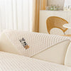 A beige plush sofa cover featuring a graphic of two dogs on a light-colored bed.