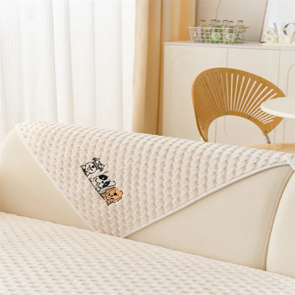 A beige plush sofa cover featuring a graphic of two dogs on a light-colored bed.