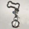 Silver pocket watch keychain featuring an adjustable clock mechanism and a key.