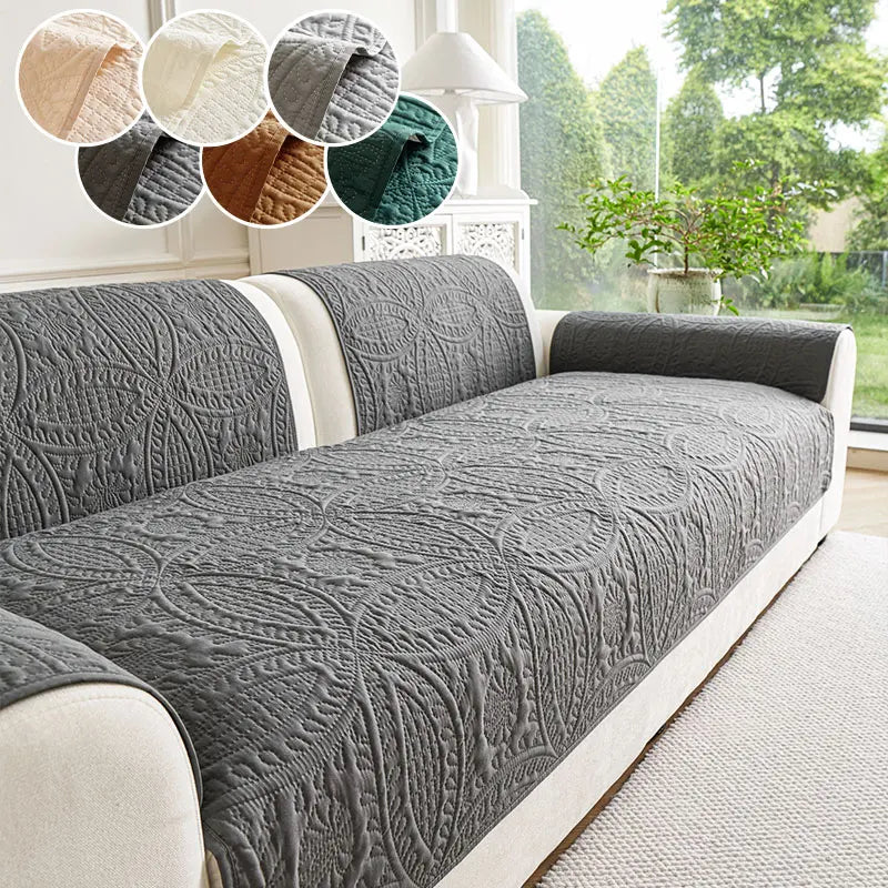 A gray anti-slip sofa cushion with a textured pattern is displayed on a light-colored sofa.