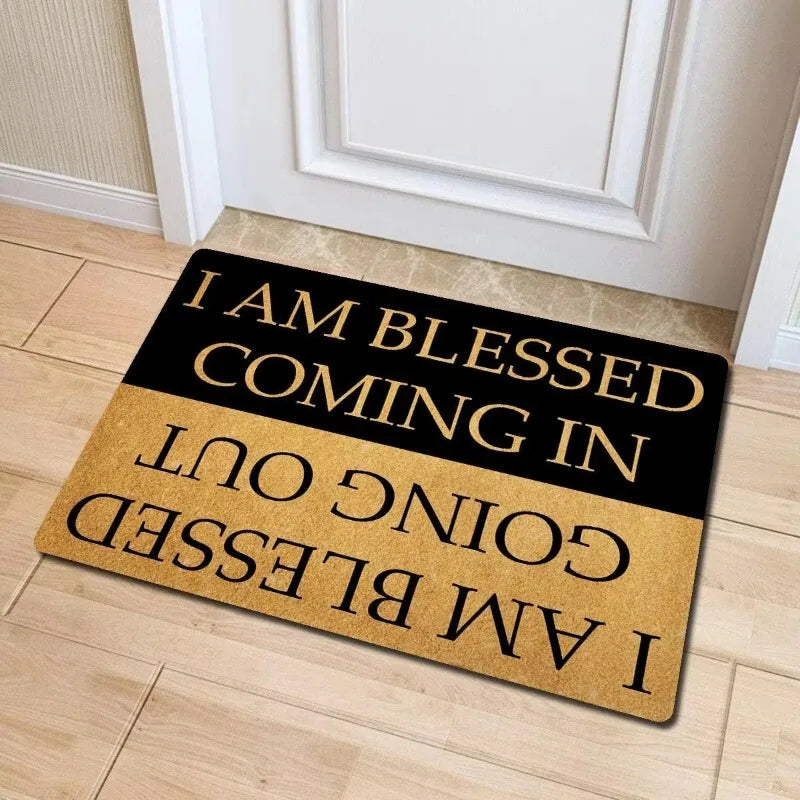 A black and gold doormat with the text I am blessed coming in going out and I am blessed.