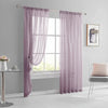 A pair of sheer lavender curtains hanging on a rod in a bright room.