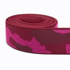 A roll of magenta camouflage elastic stretch ribbon for sewing and craft projects.