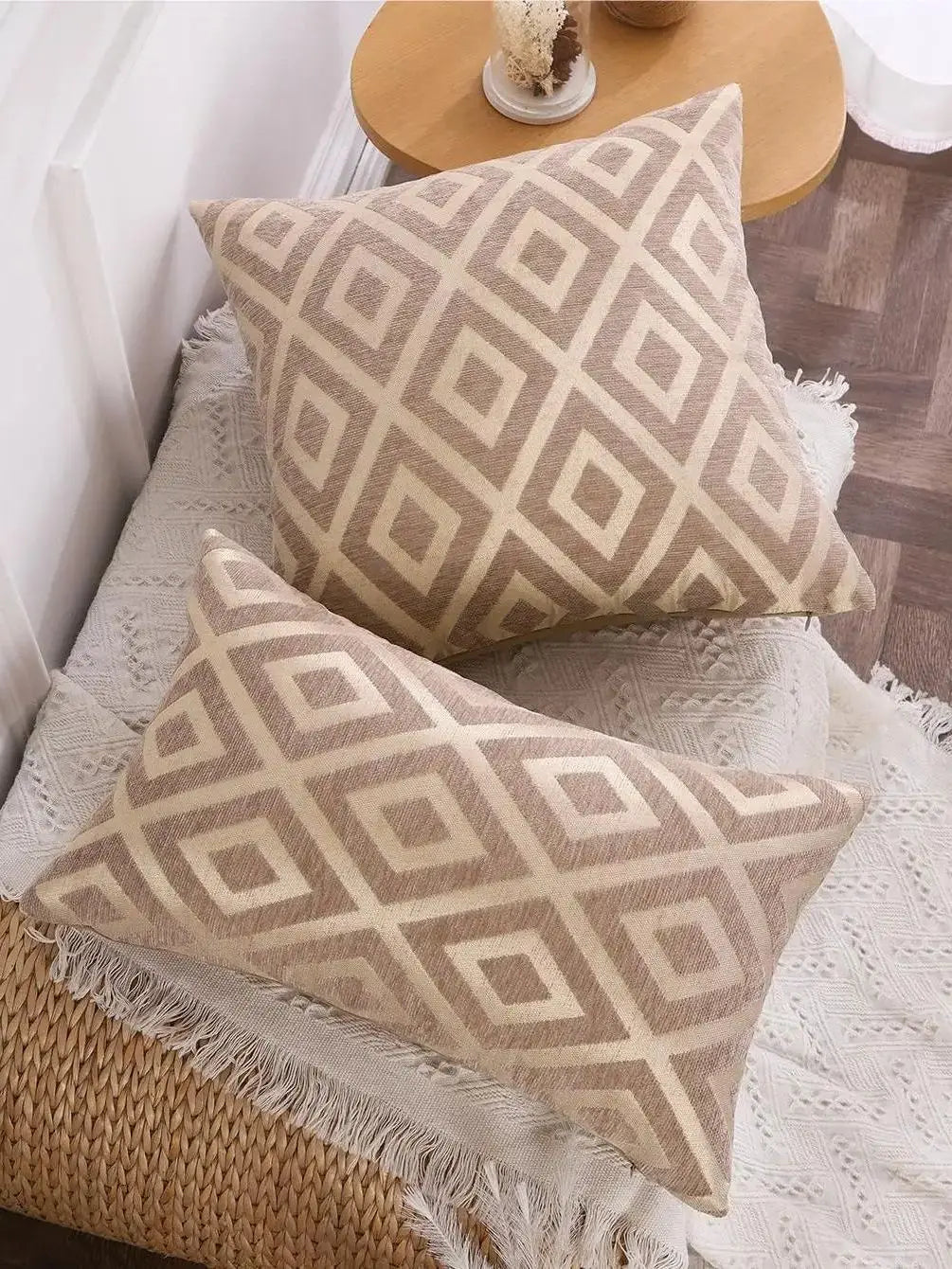 A beige chenille jacquard throw pillowcase with a diamond pattern resting on a white textured surface.