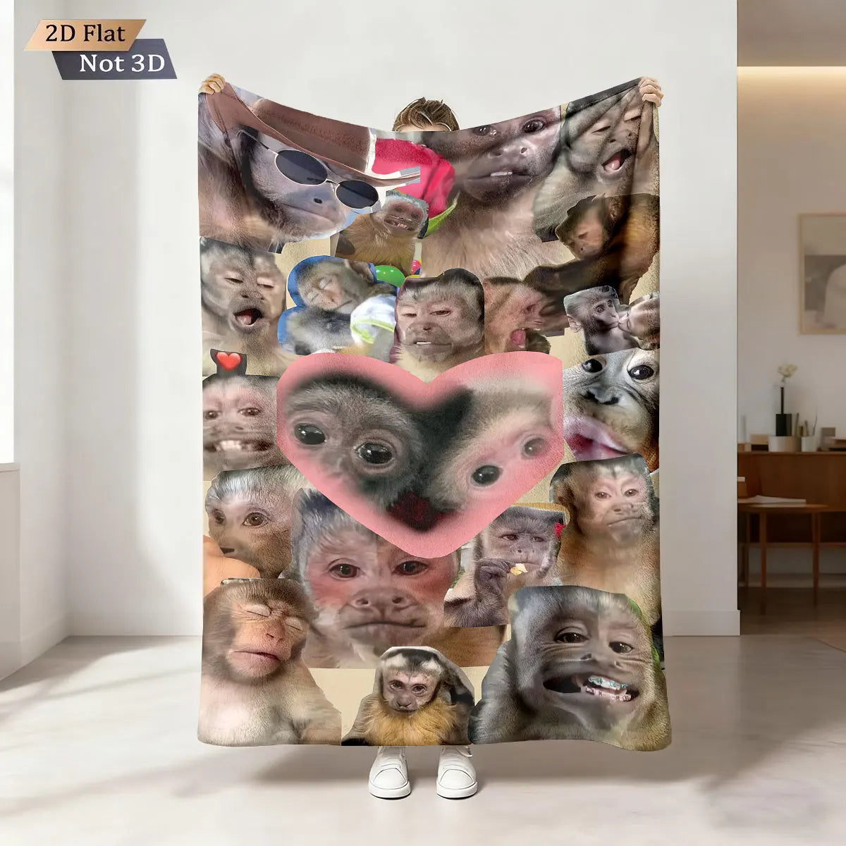 A flat print of various monkey faces on a fabric, displayed against a white wall.