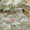A light green and white duvet cover set featuring a pattern of small yellow rabbits and pink flowers, with matching pillows a