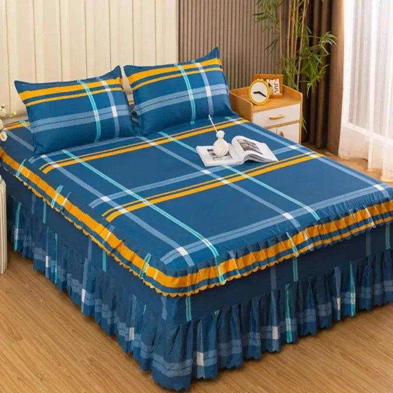 A set of three blue and yellow plaid fitted bed sheets with elastic lace trim displayed on a bed.