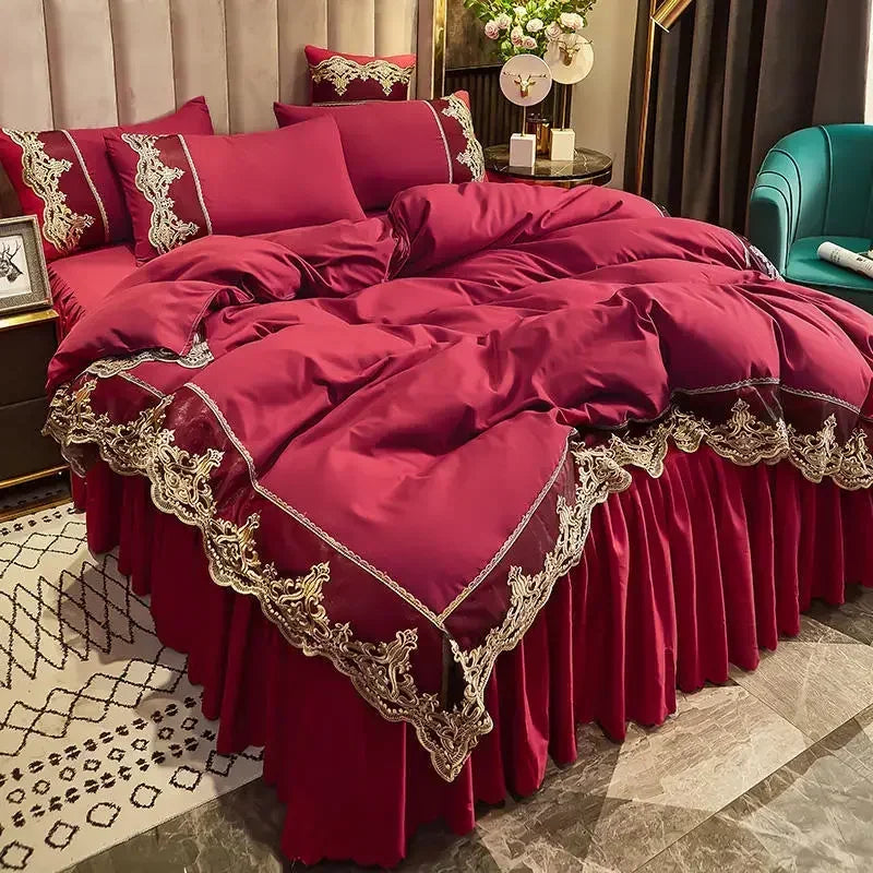 A luxurious deep red bed skirt set featuring intricate gold lace edging and gathered fabric.