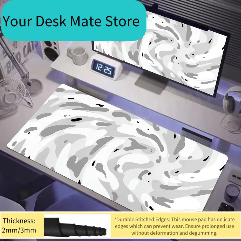A large art vortex mouse pad with a gray and white swirling pattern is displayed on a desk next to a monitor.