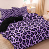 A purple and black leopard print duvet cover set displayed on a bed.