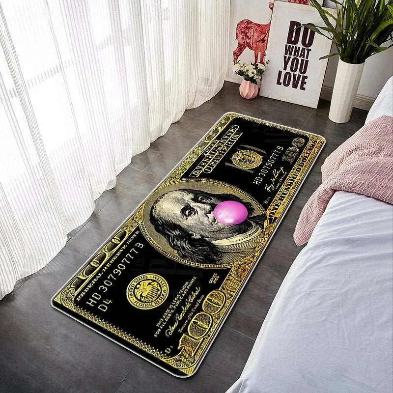 A rectangular black and gold decorative floor mat featuring a portrait and text on a wooden floor.