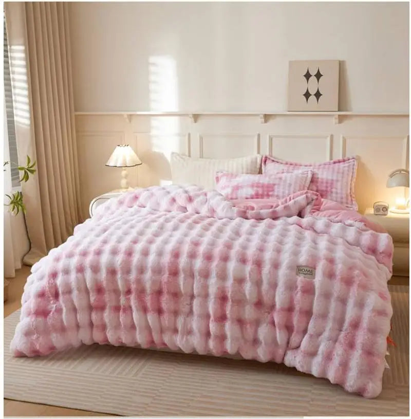 A pink and white checkered plush rabbit quilt comforter displayed on a bed with light wood accents.