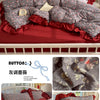 A princess style bedding set featuring gray floral patterned duvet and pillows with red ruffled trim on a white wooden bed.