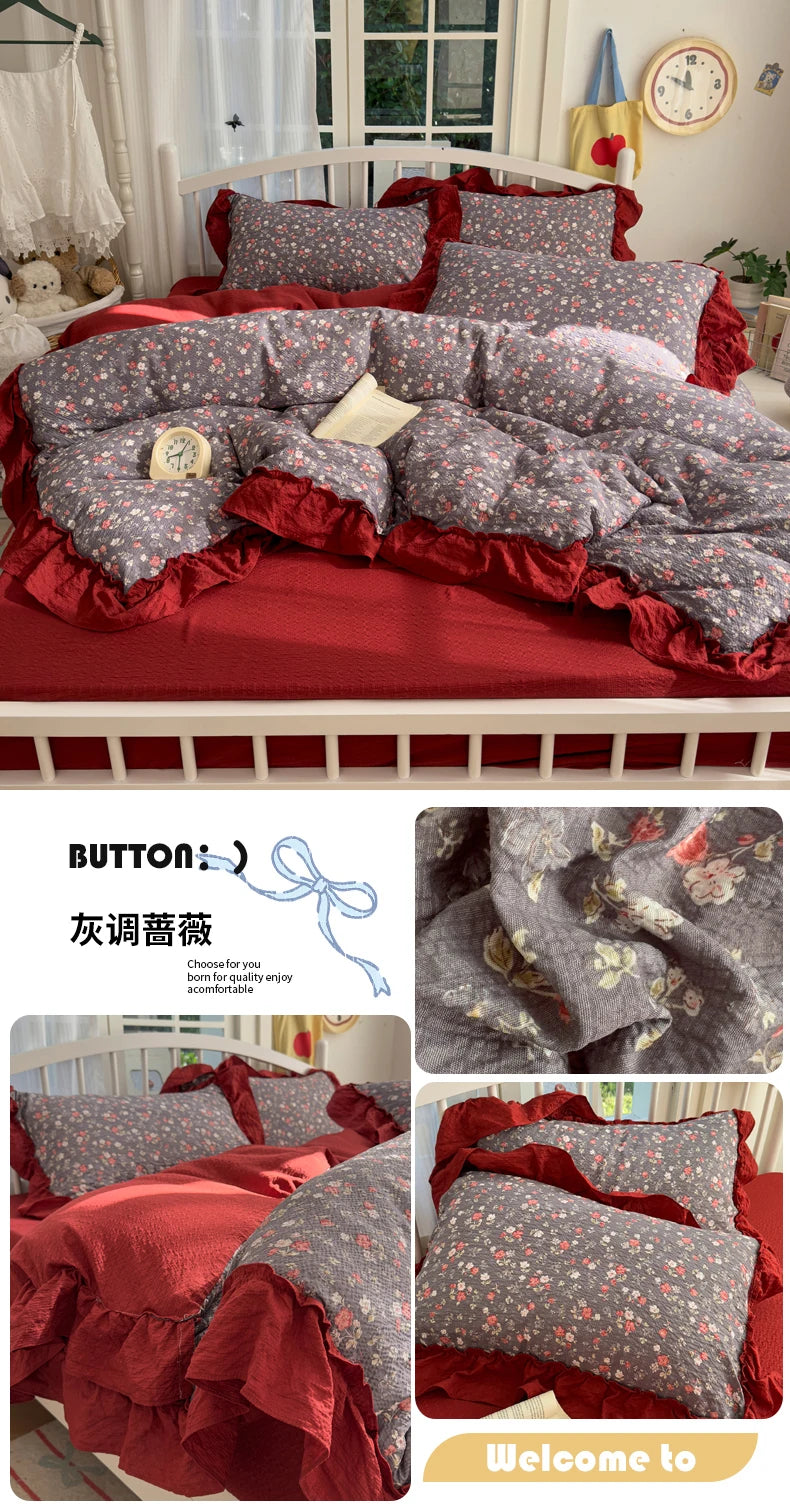 A princess style bedding set featuring gray floral patterned duvet and pillows with red ruffled trim on a white wooden bed.