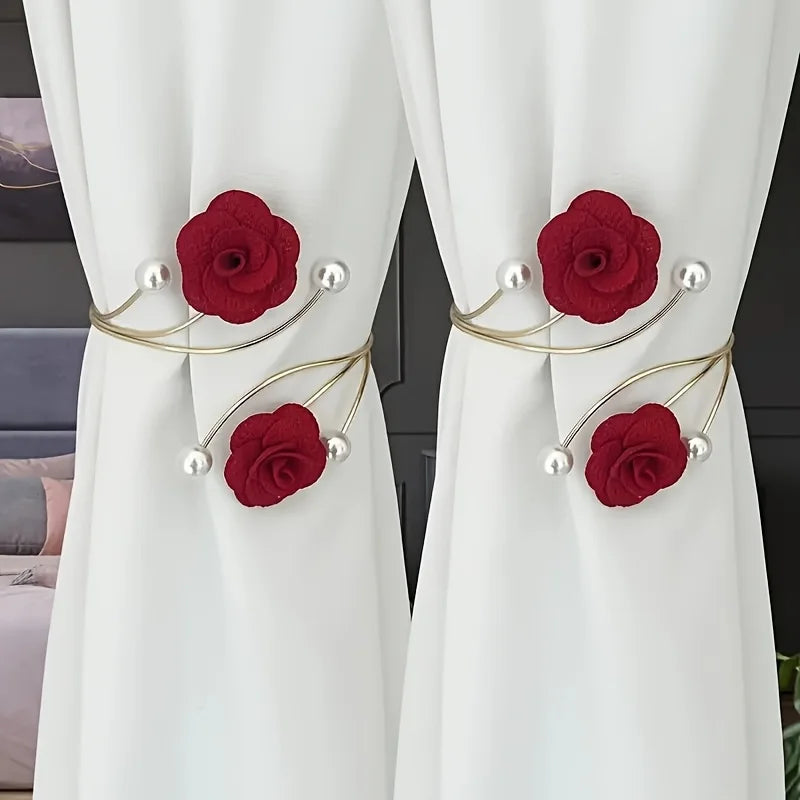 Red rose pattern curtain ties with adjustable gold metal buckles and pearl accents on white fabric.