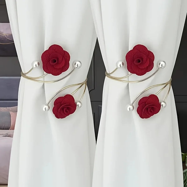 Red rose pattern curtain ties with adjustable gold metal buckles and pearl accents on white fabric.