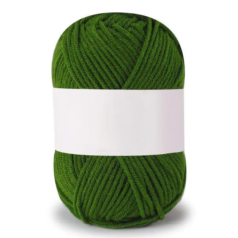A ball of soft milk cotton knitting yarn in a vibrant green color.