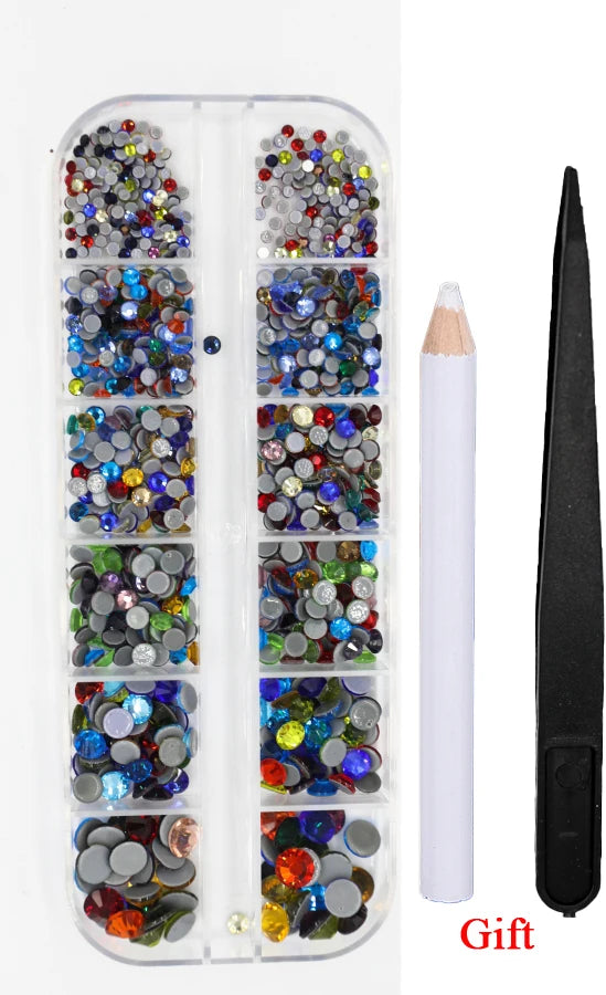 A clear plastic case containing various colored rhinestones and a tool for applying them as a gift set