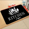Black non-slip washable kitchen mat with silverware silhouette for floor protection