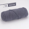 A skein of medium weight gray yarn, labeled number 16, shown rolled up.