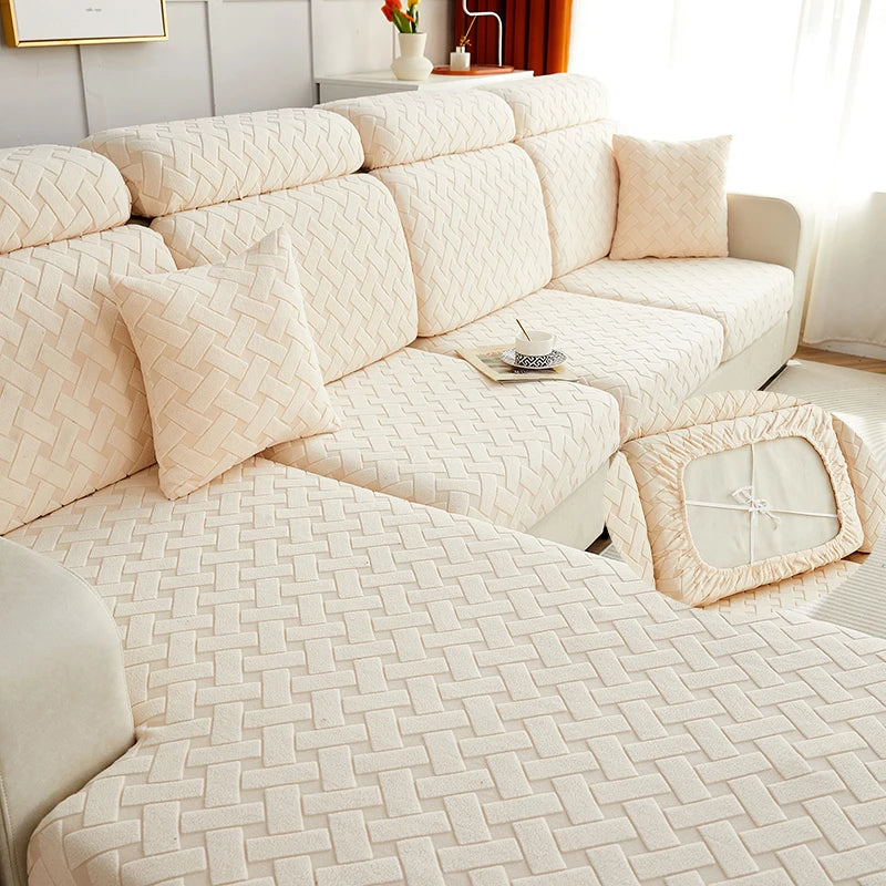 A beige jacquard plush sofa cushion cover with quilted texture and matching throw pillows on a light-colored sofa.