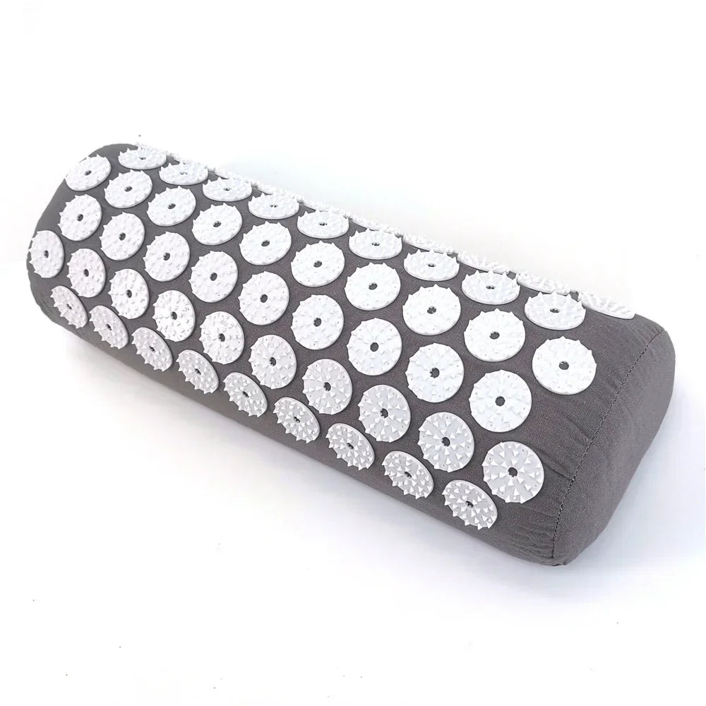 A dark gray acupressure relief mat and pillow set featuring white circular bumps.