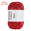 Red metallic T-shirt yarn skein with a visible label and coiled texture