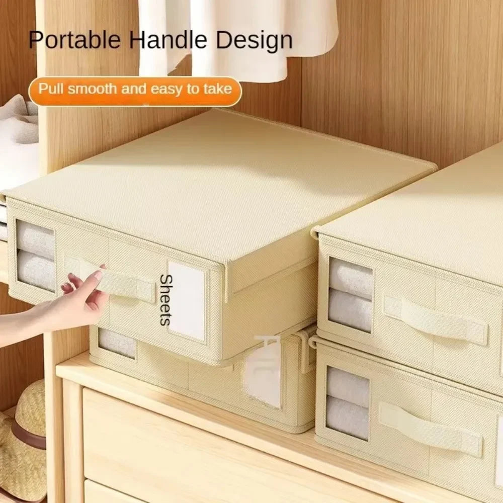 A portable handle design storage box made of light beige non-woven fabric for organizing sheets and clothing.