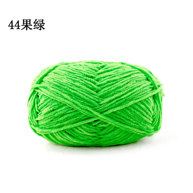 A ball of bright green 3mm matte chenille yarn for knitting and crochet.