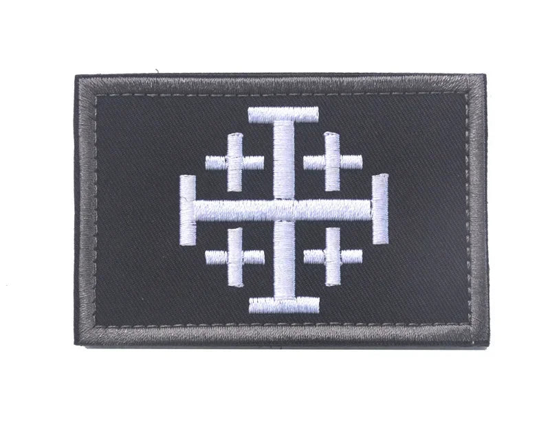 Black embroidered patch featuring a white stylized Crusader and Knight symbol.