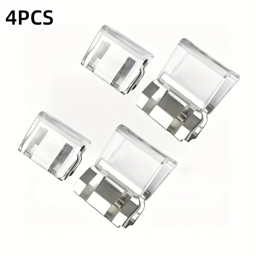 Four clear plastic invisible pant hem clips used as non-slip adjusters for trousers