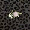 A gold-toned star-shaped pocket watch keychain with a pink face and adjustable clock mechanism.