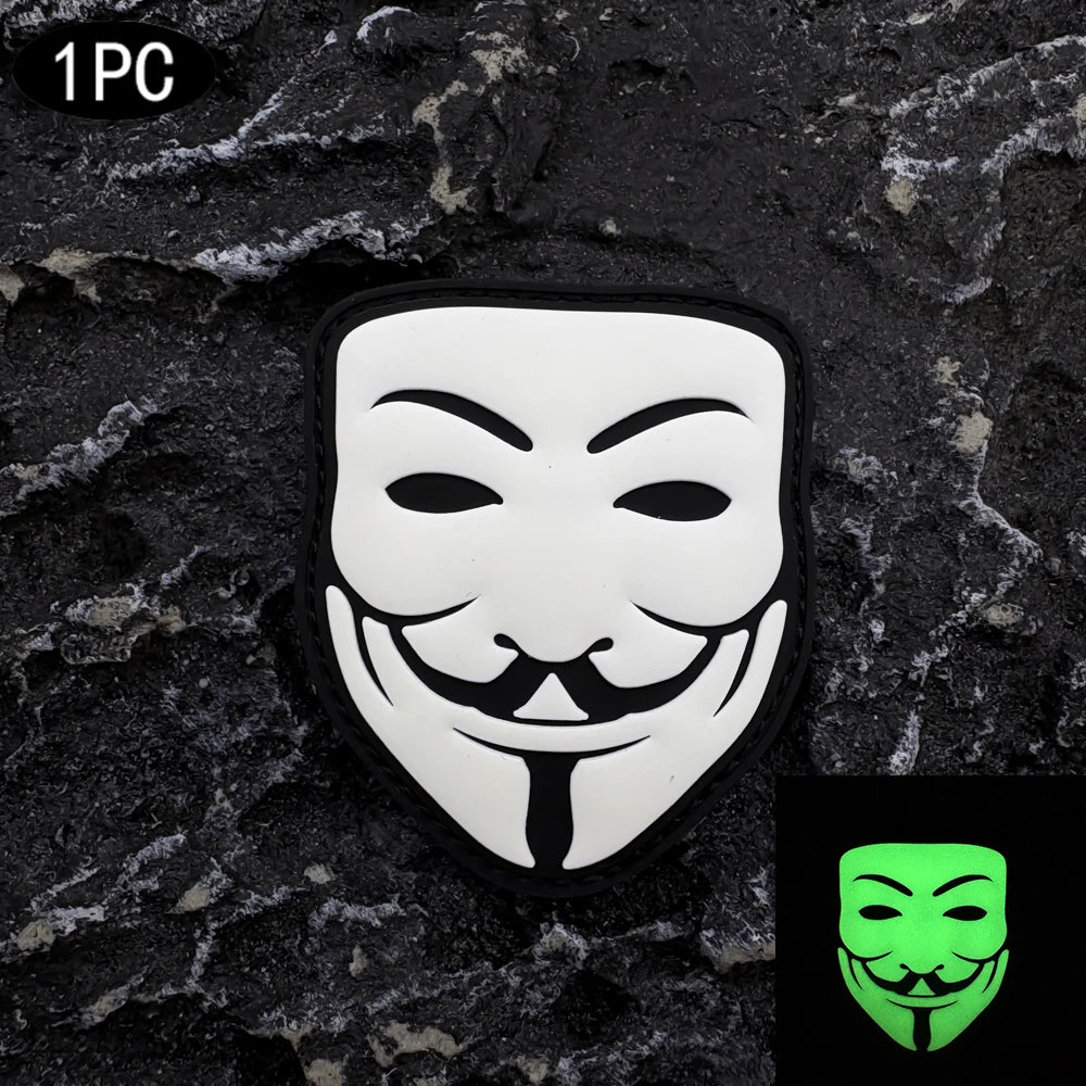 A black textured surface features a white embroidered smiley face patch with a black mustache and tie.