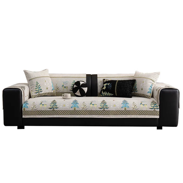 A beige sofa mat cover featuring a Christmas deer pattern with green and blue accents.
