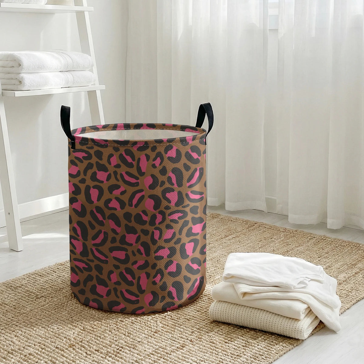 A brown leopard print foldable laundry basket sitting on a beige rug next to sheer white curtains.
