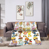 A plush throw blanket featuring colorful strawberry shortcake characters and fruit designs.