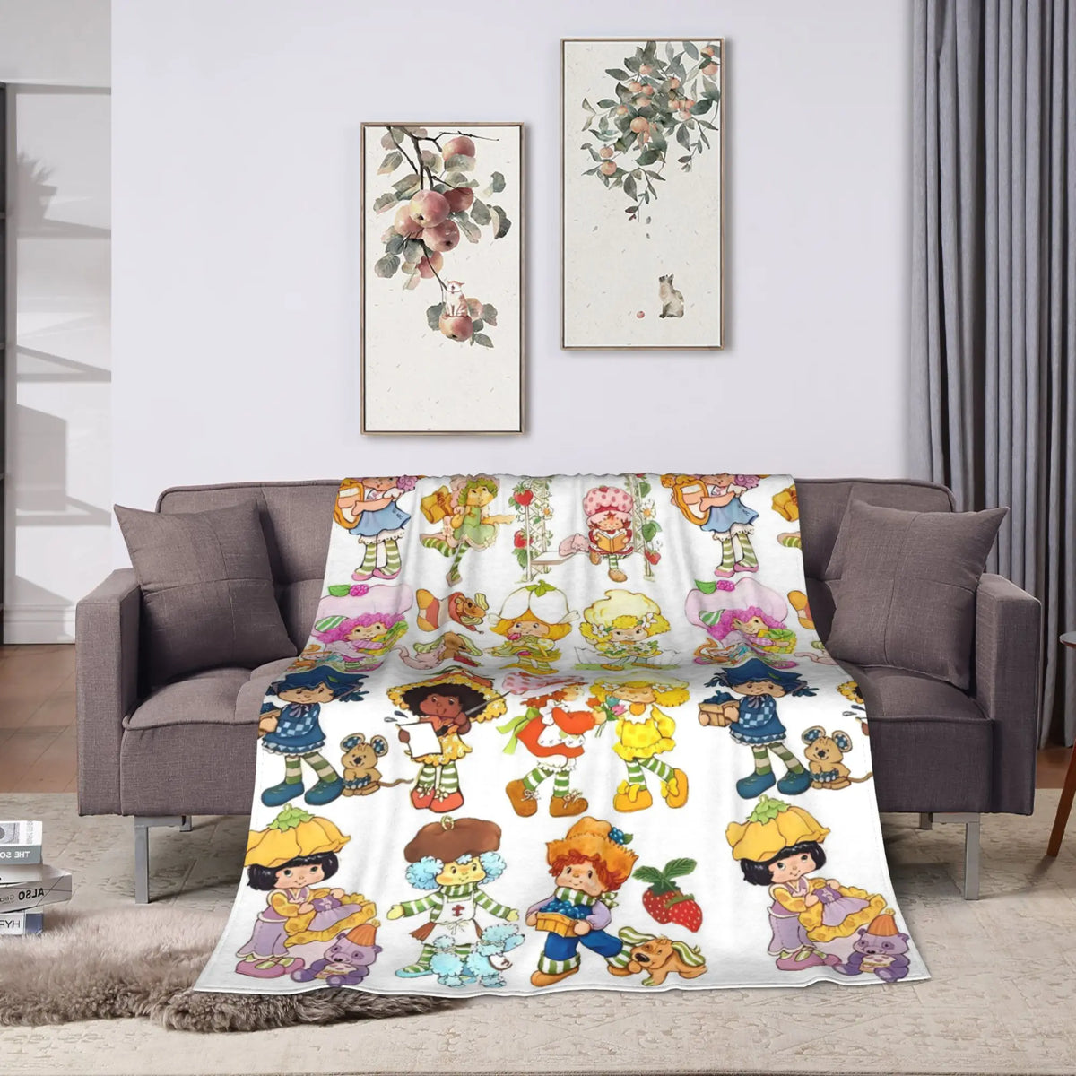 A plush throw blanket featuring colorful strawberry shortcake characters and fruit designs.