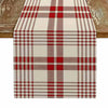 A linen checkered table runner featuring a red and white plaid pattern on a wooden surface.