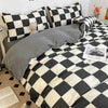 A black and white plaid duvet cover set featuring a checkered pattern on a bed.